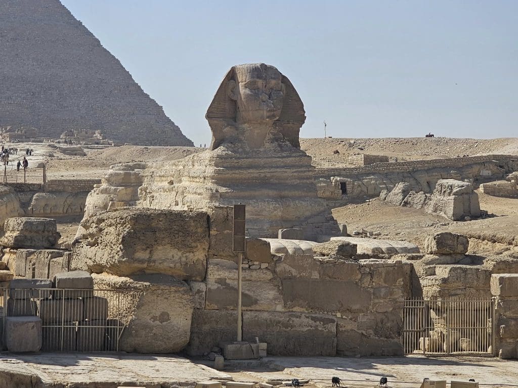 Image of the Sphinx in Egypt with landscape including pyramids.