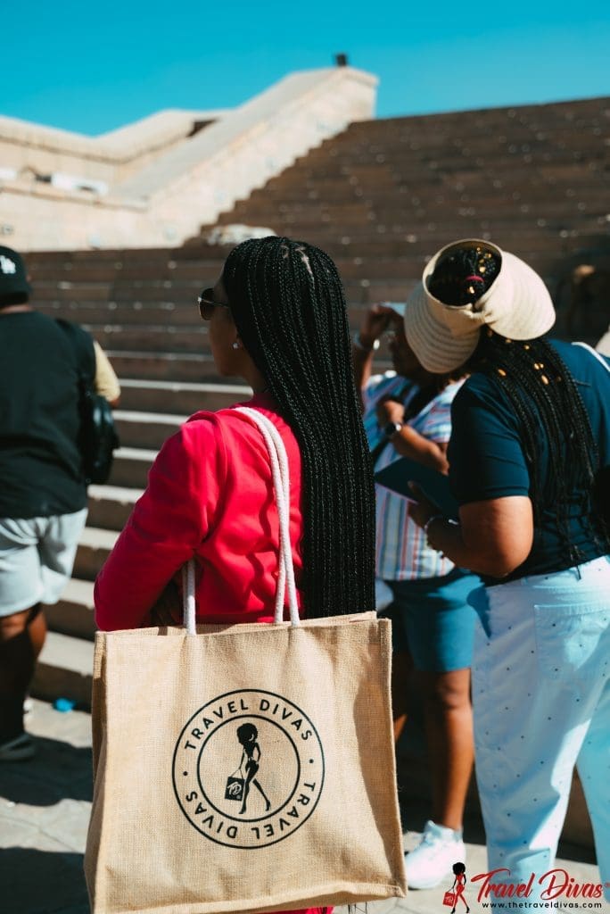 travel diva with braids, travel diva bag and another with a straw hat