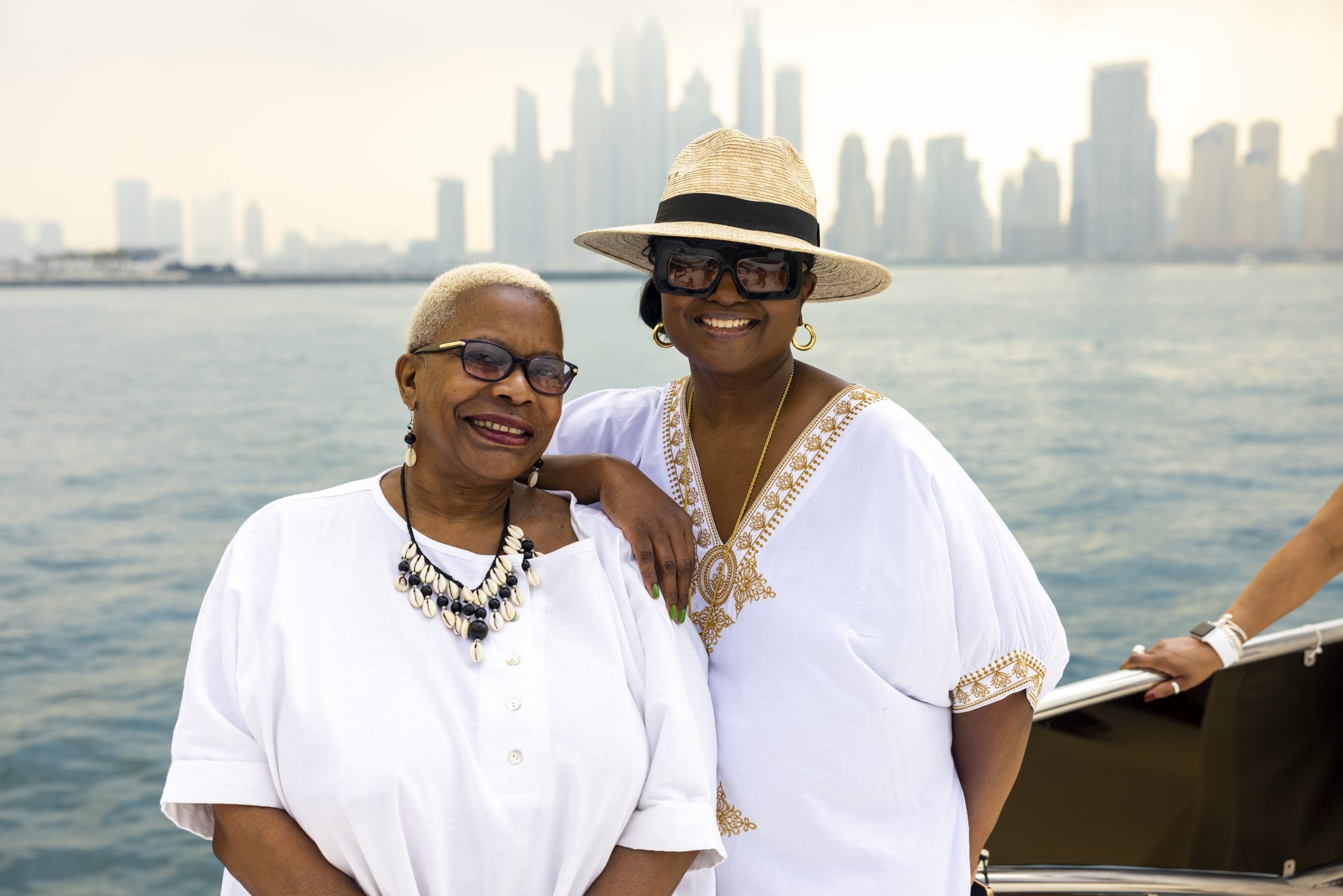 Black woman on yacht with white casual wear in Dubai